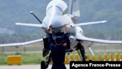 FILE - A Chinese J-10 fighter jet is being guided on the tarmac following a flight demonstration at China's 13th International Aviation and Aerospace Exhibition, in Zhuhai, in southern China's Guangdong province, Sept. 28, 2021. 