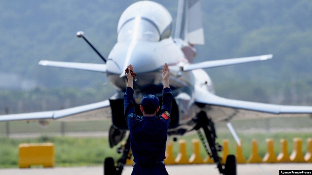 FILE - A Chinese J-10 fighter jet is being guided on the tarmac following a flight demonstration at China's 13th International Aviation and Aerospace Exhibition, in Zhuhai, in southern China's Guangdong province, Sept. 28, 2021. (Photo by Noel Celis / AFP)