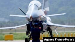 FILE - A Chinese J-10 fighter jet is being guided on the tarmac following a flight demonstration at China's 13th International Aviation and Aerospace Exhibition, in Zhuhai, in southern China's Guangdong province, Sept. 28, 2021. 