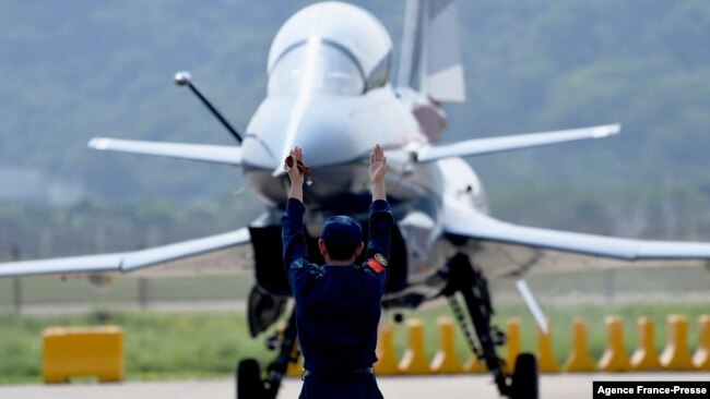 FILE - A Chinese J-10 fighter jet is being guided on the tarmac following a flight demonstration at China's 13th International Aviation and Aerospace Exhibition, in Zhuhai, in southern China's Guangdong province, Sept. 28, 2021. (Photo by Noel Celis / AFP)