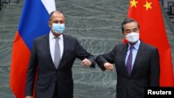 Russia's Foreign Minister Sergei Lavrov and China's State Councilor and Foreign Minister Wang Yi