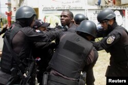 A man is detained by police as he takes part in a protest against the unfinished public works in Colon, Panama, March 13, 2018.