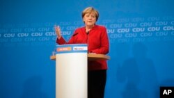 German Chancellor Angela Merkel addresses journalists at a news conference to announce that she will run again for the chancellorship in next year's general elections, at the Christian Democratic Union Party (CDU) headquarters in Berlin, Germany, Nov. 20