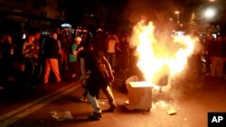 Protestors burn furniture taken from the demolished President’s office in Skopje, Macedonia, April 13, 2016. Opposition supporters gathered in Skopje for a second day to demand the resignation of President Gjorge Ivanov after he pardoned 56 people from both ruling parties and the opposition.