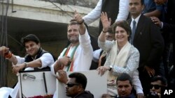 India's Congress party President Rahul Gandhi, center, gestures with the party's general secretaries Priyanka Gandhi Vadra, right, and Jyotiraditya Scindia, left, by his side during a rally in Lucknow, India, Feb. 11, 2019.