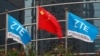 FILE - A Chinese national flag and two flags bearing the name of ZTE fly outside the ZTE R&D building in Shenzhen, China, April 27, 2016. 