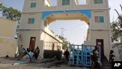 Somali soldiers stand guard at the main gate of the presidential palace in Mogadishu, July, 9, 2014.