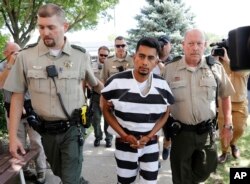 Cristhian Bahena Rivera is escorted into the Poweshiek County Courthouse for his initial court appearance, Aug. 22, 2018, in Montezuma, Iowa.