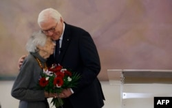 FILE - German President Frank-Walter Steinmeier hugs German Holocaust survivor Margot Friedlander as she arrives to take part in talks titled "War in the Middle East: For a peaceful life together in Germany" on November 8, 2023 at the presidential Bellevue Palace in Berlin.