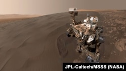 FILE - This self-portrait of NASA's Curiosity Mars rover shows the vehicle at "Namib Dune," where the rover's activities included scuffing into the dune with a wheel and scooping samples of sand for laboratory analysis.