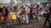 Residents carry their belongings as they flee from Kibati, where fighting has intensified, towards the city of Goma, Democratic Republic of Congo, Jan. 26, 2025. 