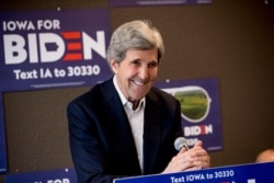 FILE - In this Jan. 9, 2020, file photo former Secretary of State John Kerry smiles while speaking at a campaign stop to support Democratic presidential candidate former Vice President Joe Biden in Fort Dodge, Iowa.