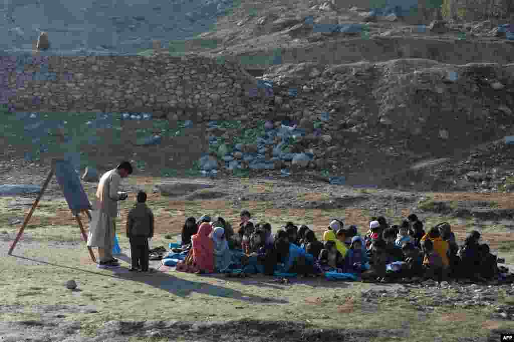 School children attend an open-air classroom in Qarghayi district of Laghman Province, Afghanistan.