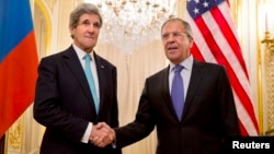 FILE - U.S. Secretary of State John Kerry, left, shakes hands with Russian Foreign Minister Sergei Lavrov before their meeting in Paris last March; the two will confer again next week in Geneva.