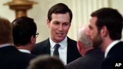 FILE - White House adviser Jared Kushner speaks with people as they wait for President Donald Trump to arrive in the East Room of the White House, June 29, 2018.