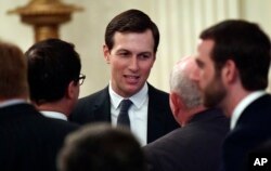 FILE - In this June 29, 2018, file photo, White House adviser Jared Kushner speaks with people as they wait for President Donald Trump to arrive in the East Room of the White House.