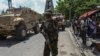 FILE - A Kenyan police officer, part of a UN-backed multinational force, gestures on July 17, 2024, for journalists to move in Port-au-Prince, Haiti. 