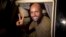 Saif al-Islam, son of Moammar Gadhafi, makes a peace sign before meeting reporters in Tripoli, Libya, Aug. 23, 2011.