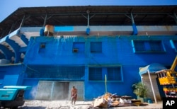 A worker uses a jackhammer on the path outside the Estadio Latinoamericano baseball arena in Havana, Cuba, March 1, 2016.