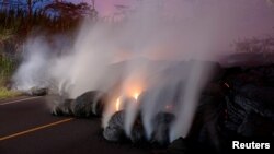 Volcanic gases rise from the Kilauea lava flow that crossed Pohoiki Road near Highway 132, near Pahoa, Hawaii, May 28, 2018. 
