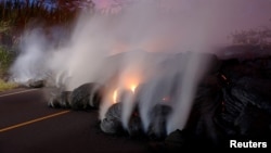 Volcanic gases rise from the Kilauea lava flow that crossed Pohoiki Road near Highway 132, near Pahoa, Hawaii, May 28, 2018.