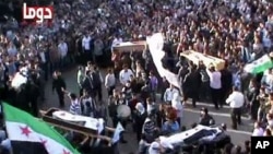 An image taken from a video uploaded on YouTube on April 5, 2012, shows the funeral of five Syrian men in Duma near the capital, Damascus.