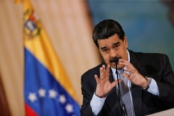 Venezuela's President Nicolas Maduro gestures as he speaks during a news conference in Caracas, Venezuela, Sept. 30, 2019.