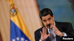 Venezuela's President Nicolas Maduro gestures as he speaks during a news conference in Caracas, Venezuela, Sept. 30, 2019.