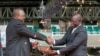 Kenya's President William Ruto receives instruments of his power and authority from his predecessor Uhuru Kenyatta during his swearing-in ceremony in Nairobi