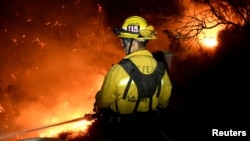 Firefighters battle the Thomas fire in the hills and canyons outside Montecito, California, Dec. 16, 2017. 