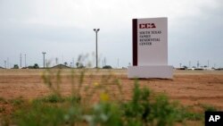 This June 30, 2015, file photo shows a sign at the entrance to the South Texas Family Residential Center in Dilley, Texas. A judge has ordered Dec. 24, 2018, the U.S. government not to deport a Honduran woman without her 15-year-old daughter. 
