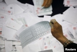 National Election Commission officials count ballots at a ballot count location in Seoul, South Korea, April 13, 2016.