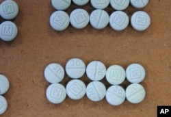This undated photo provided by the Cuyahoga County Medical Examiner’s Office shows fentanyl pills.