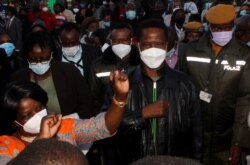 Zambian President Edgar Lungu greets supporters after casting his ballot in Lusaka, Zambia, August 12, 2021. REUTERS/Jean Ndaisenga