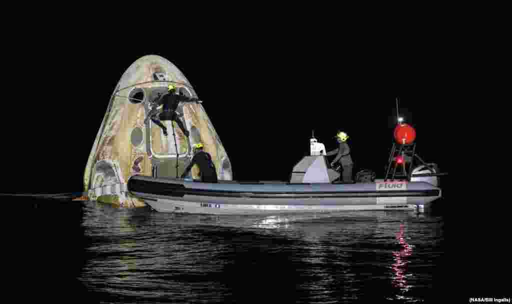 Support teams work around the SpaceX Crew Dragon Resilience spacecraft after shortly it landed with NASA astronauts and a Japanese astronaut aboard in the Gulf of Mexico off the coast of Panama City, Florida. (Credit: NASA)