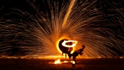 Malay artists perform a fire sparkling performance on a beach side during the Christmas festive season and school holidays on Pangkor Island, Malaysia, Dec. 26, 2024. 