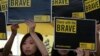 Supporters raise placards outside a court in Hong Kong, April 9, 2019.