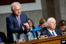 FILE - Chairman Sen. Bob Corker, left, and Ranking Member Sen. Ben Cardin, right, are seen hearing testimony during a Senate Foreign Relations Committee hearing on Capitol Hill, in Washington, July 23, 2015.