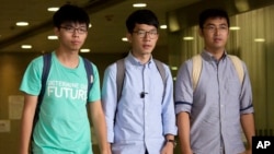 Three Hong Kong student protest leaders, from left, Joshua Wong, Nathan Law and Alex Chow walk out from a magistrate's court in Hong Kong, Monday, Aug. 15, 2016. 