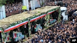 Mourners gather around a truck carrying coffins of Iranian President Ebrahim Raisi and his companions who were killed in their helicopter crash in mountainous region of the country's northwest, during a funeral ceremony at the city of Tabriz, May 21, 2024. (Fars News Agency)