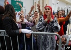 Women cheer as they wait for Pope Francis to arrive at the Mohammed VI Institute, a school of learning for imams, in Rabat, Morocco, March 30, 2019.