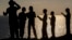 Ultra-Orthodox Jewish boys pray along the Mediterranean Sea in the Israeli city of Herzliya, near Tel Aviv, while performing the "Tashlich" ritual during which "sins are cast into the water to the fish."