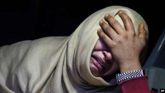 A woman cries inside an ambulance after she lost her family member during a heavy snowfall-hit area in Murree, Pakistan, Jan. 8, 2022.