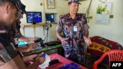 FILE - Bangladesh Border Guard (BGB) personnel lay out small bags of the drug yaba recovered from a passenger bus during a search at a checkpost along the Teknaf-Cox's Bazar highway in Teknaf, Bangladesh, April 6, 2018.