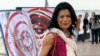 File: Activist and lawyer Seng Chan Theary poses with dartboard posters during a protest in Phnom Penh, Cambodia, Nov. 18, 2012. (AP Photo/Luke Hunt)