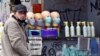 A gray market salesman sells face masks and hand sanitizer at a street corner in Sarajevo on April 22, 2020.