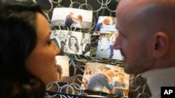 Silvia Carlucci and Domenico Fabiani, who were fired by the Vatican Bank in October 2024, after their wedding violated a ban on workplace marriage, show their wedding photos during an interview with The Associated Press in Rome, Jan. 27, 2025. 