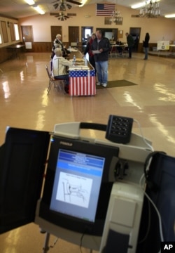 FILE - A voting machine is seen inside a VFW post in Saukville, Wisconsin.