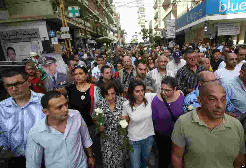 Protesters march in the Achrafieh neighborhood a day after a car bomb attack that killed Brig. Gen. Wissam al-Hassan and at least seven others in Beirut, Lebanon, October 20, 2012. 