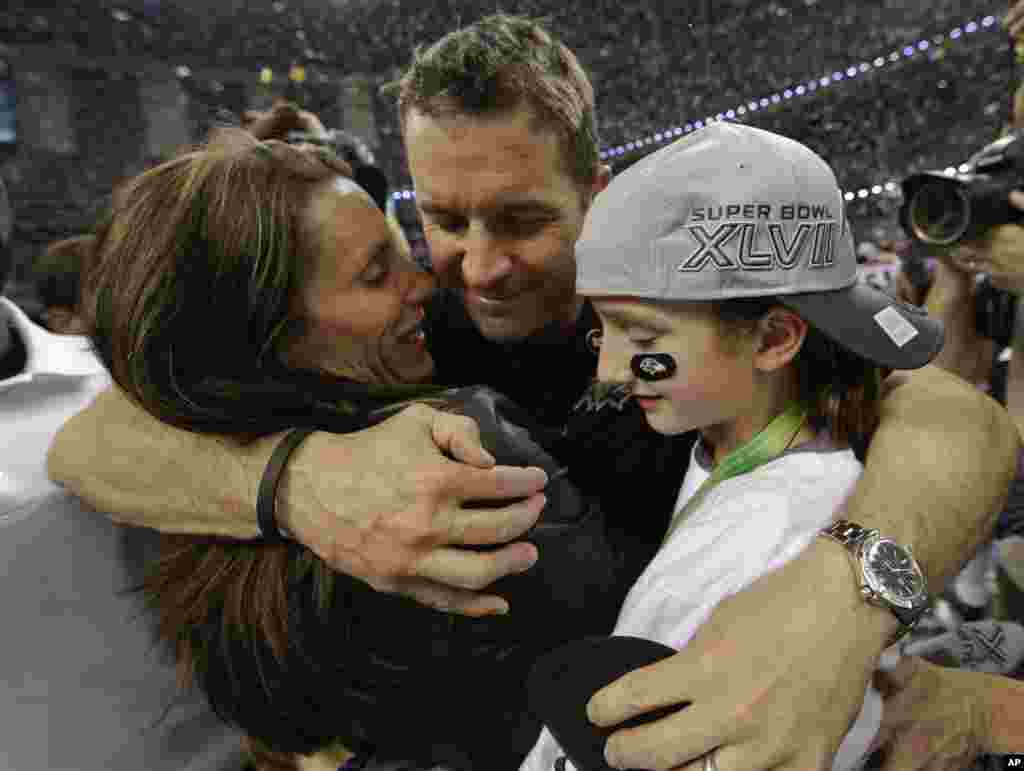 Baltimore Ravens head coach John Harbaugh hugs his wife Ingrid, left, and daughter Alison after defeating the San Francisco 49ers in the Super Bowl in New Orleans.